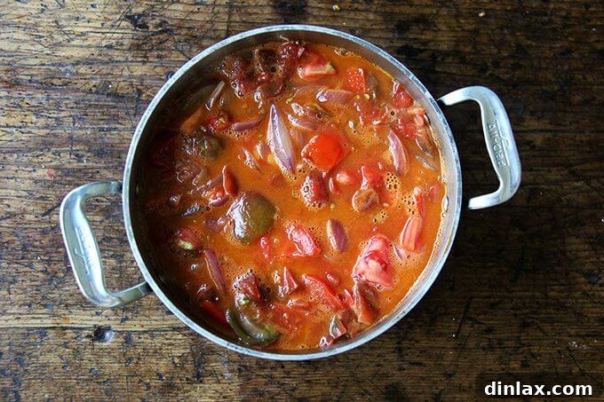 Marcella Hazan's Effortless Butter and Onion Tomato Sauce 10 A pot of tomatoes simmering with onions and butter after just a few minutes, showing early breakdown.