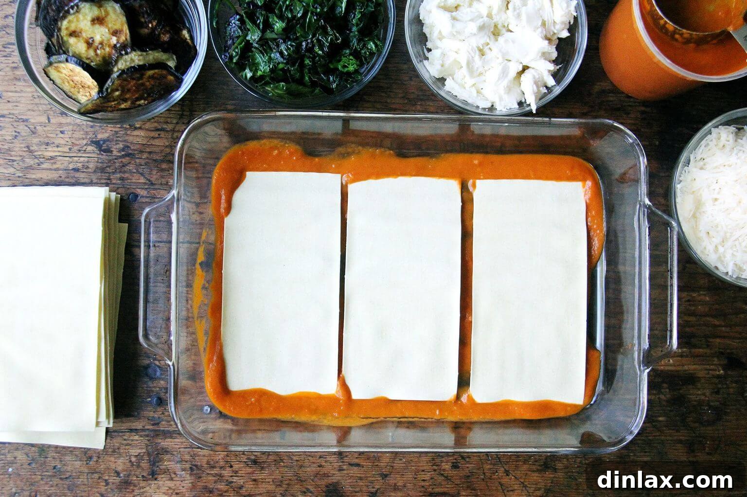 The foundational layer of sauce and no-boil noodles for the lasagna.