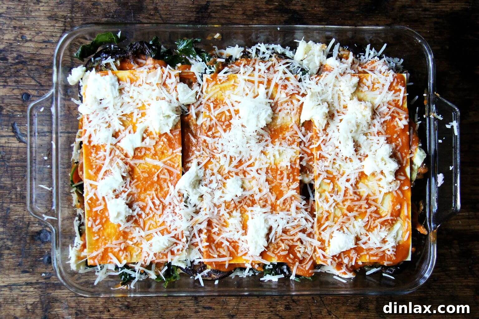 An assembled, unbaked roasted eggplant lasagna, ready for the oven.