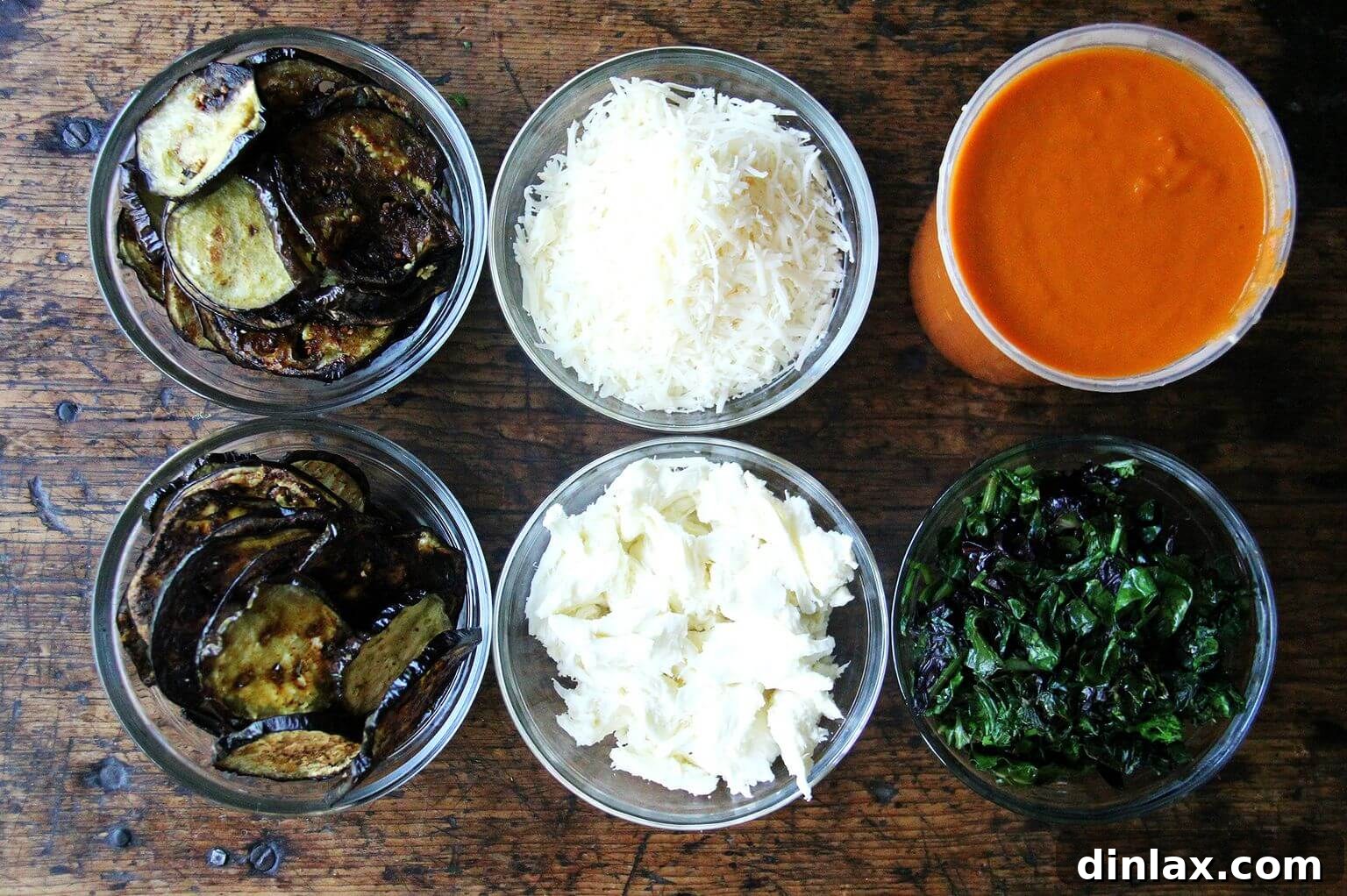 All the delicious ingredients for eggplant lasagna laid out on a table.