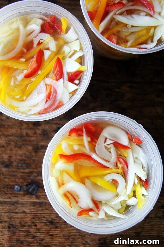 A vibrant mix of thinly sliced pickled peppers, onions, and fennel, ready to be enjoyed on pizza, sandwiches, or cheese toasts. This simple recipe brightens any dish with its tangy, refreshing flavor.