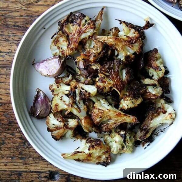 A plate of oven-roasted cauliflower florets with parmesan.