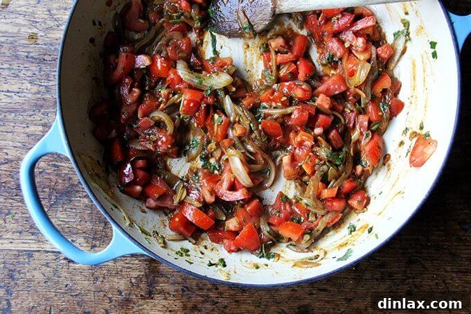 Sweet and Savory Chickpea Tagine with Tomato Jam and Roasted Delicata Squash 11 Finely diced tomatoes added to the braiser, creating the rich base for the 'tomato jam' in the Chickpea Tagine.
