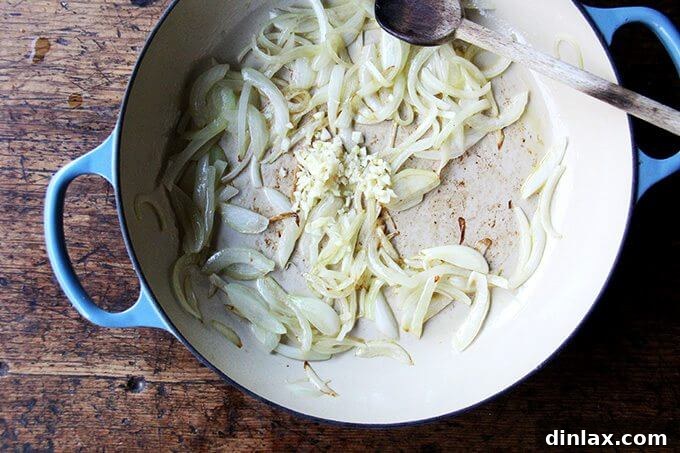 Sweet and Savory Chickpea Tagine with Tomato Jam and Roasted Delicata Squash 7 Minced garlic cloves added to the softened onions in the Le Creuset braiser, releasing their fragrant aroma.
