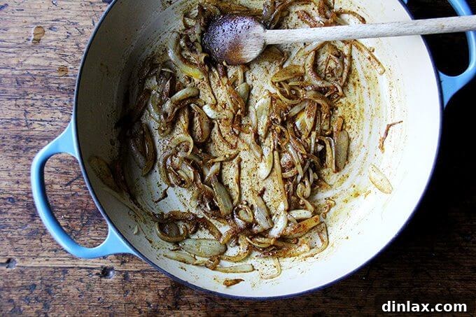 Sweet and Savory Chickpea Tagine with Tomato Jam and Roasted Delicata Squash 8 Ras el hanout spice blend sprinkled over the sautéed onions and garlic, ready to be stirred in and toasted.