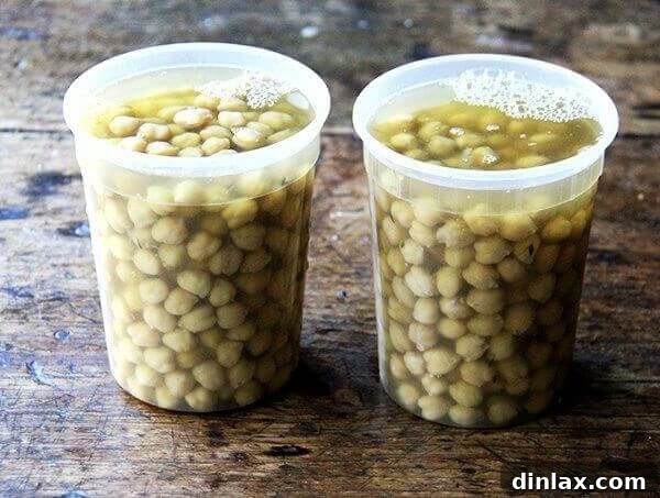 Two quart containers filled with cooked chickpeas.