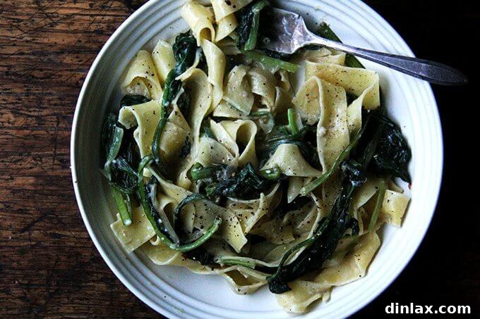 A close-up shot of a bowl filled with the creamy, greens-laden no-bacon carbonara, highlighting its inviting texture and vibrant ingredients.
