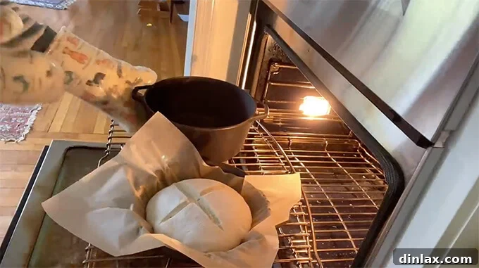Mastering Sourdough: A Step-by-Step Homemade Journey 15 A loaf of sourdough bread baking in a Dutch oven inside the oven.