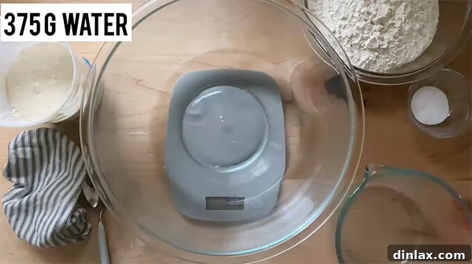 Mastering Sourdough: A Step-by-Step Homemade Journey 6 A bowl on a digital scale displaying 375 grams of water.