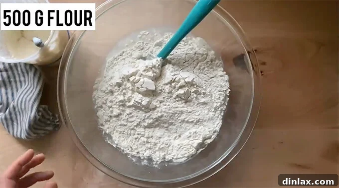 Mastering Sourdough: A Step-by-Step Homemade Journey 9 A bowl holding water, salt, flour, and sourdough starter.