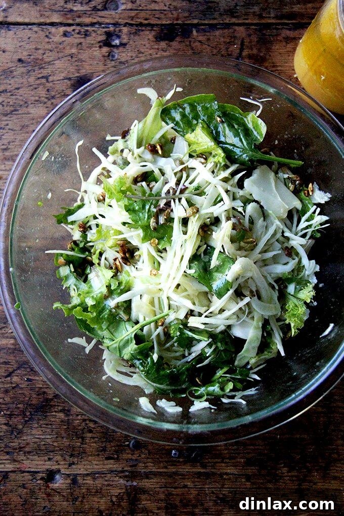 Crisp Autumn Salad with Cabbage, Fennel, Manchego, and Candied Pepitas 2 A large serving bowl filled with a tossed fall salad, vibrant and ready to be served.