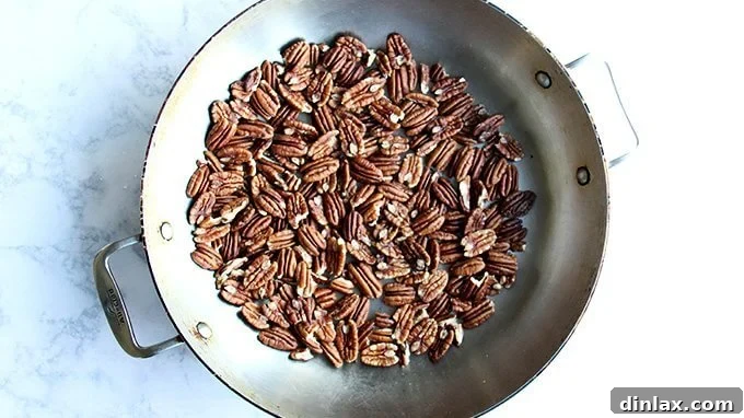 Naturally Sweet Bourbon Pecan Pie 15 Pecans toasting gently in a skillet over low heat.