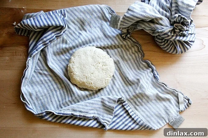 Naturally Sweet Bourbon Pecan Pie 10 A tea towel gathered into a 'beggar's purse' shape, containing a round of pastry dough.