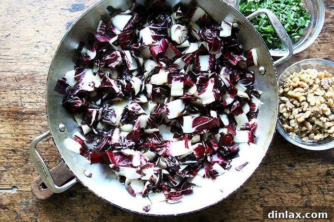 A serving of radicchio and Gorgonzola pasta on a white plate, ready to be enjoyed.