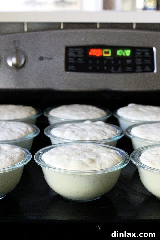 Freshly baked peasant bread loaves, golden-brown and perfectly risen, removed from the oven.