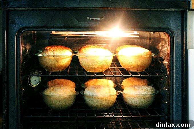 A slice of peasant bread, revealing its soft interior, served with butter.