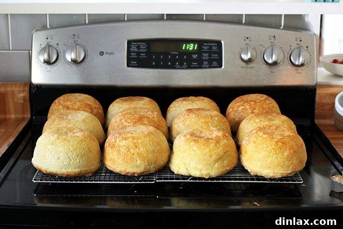 A hand holding a thick slice of freshly baked peasant bread, highlighting its rustic appeal.