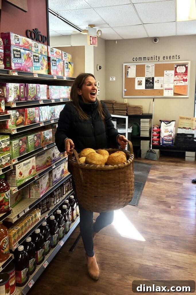 Close-up photograph of the open, airy crumb structure of a slice of peasant bread.
