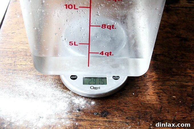 Pouring water into a bowl of dry ingredients to form the bread dough.