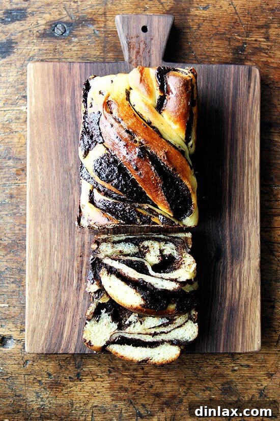 A beautifully cut loaf of orange-chocolate babka, revealing its elegant swirl of rich filling and inviting texture.