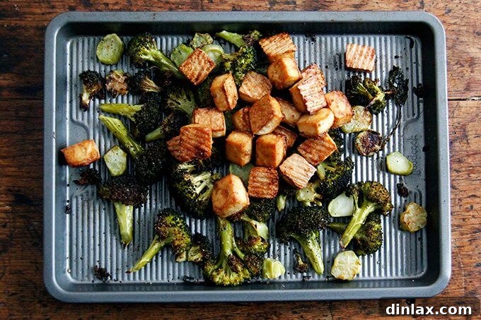 Golden Tofu and Broccoli with Savory Peanut Sesame Pesto 12 Crispy tofu and roasted broccoli are combined in a large bowl and being tossed with the sesame-peanut pesto, ensuring an even coating.