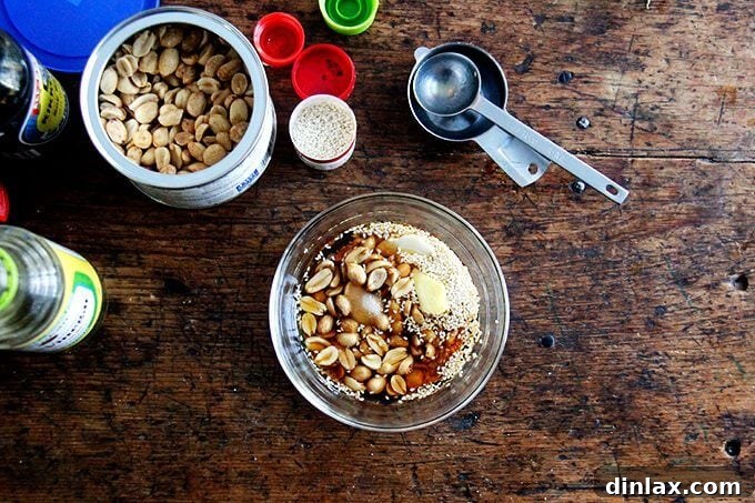 Golden Tofu and Broccoli with Savory Peanut Sesame Pesto 7 Ingredients for the sesame-peanut pesto, including roasted peanuts, sesame seeds, fresh ginger, garlic, and liquids, ready to be blended.