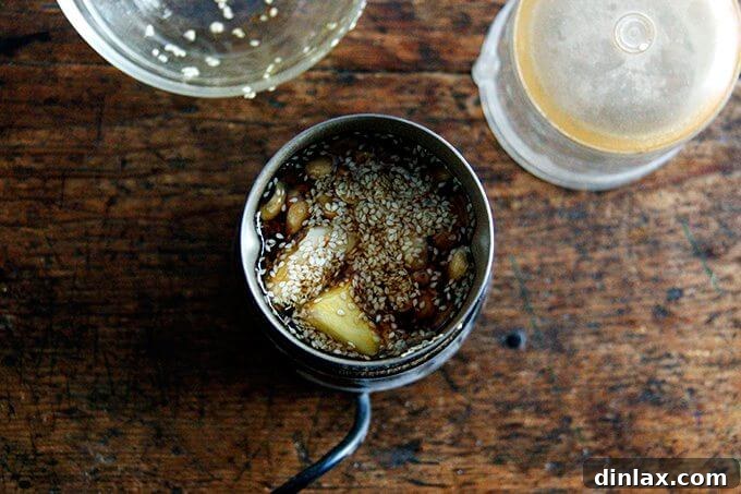 Golden Tofu and Broccoli with Savory Peanut Sesame Pesto 9 A coffee grinder being used to pulse the pesto ingredients, demonstrating an alternative method for making the sauce without a large food processor.