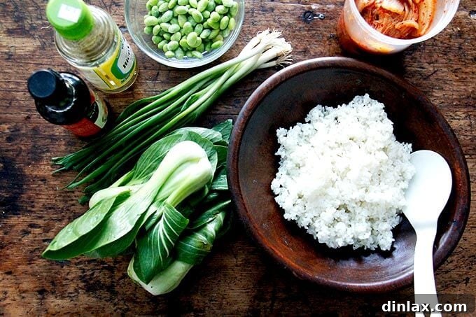 A pristine bowl of fluffy white rice sits on a rustic wooden table, awaiting its transformation into delicious fried rice.
