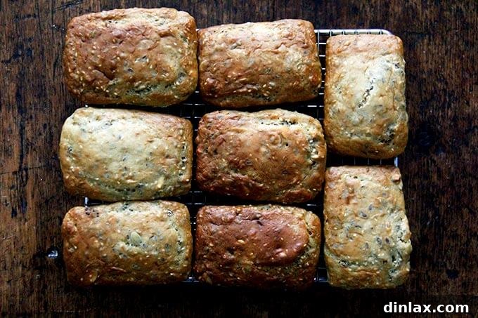 Three Seed Crisps 12 Rows of three-seed cracker loaves resting on a wire cooling rack, preparing for the freezing process.