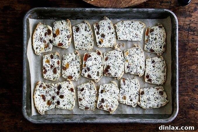Three Seed Crisps 16 Thinly sliced three-seed crackers spread out on a sheet pan, ready to be baked until golden and crisp.