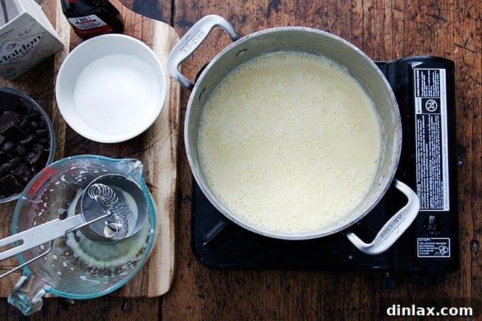 An over head shot of a portable burner holding a cream-egg yolk mixture. 