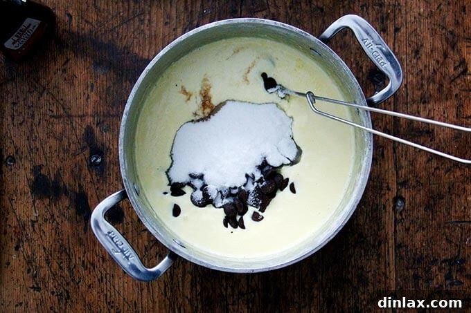An overhead shot of a pot filled with an egg-cream custard, sugar, and chocolate. 