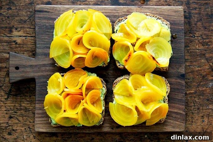 Avocado toasts topped with elegant beet roses, ready for final garnishing.