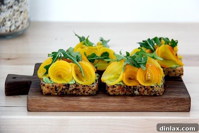 A serving board laden with beautifully garnished beet tartines.