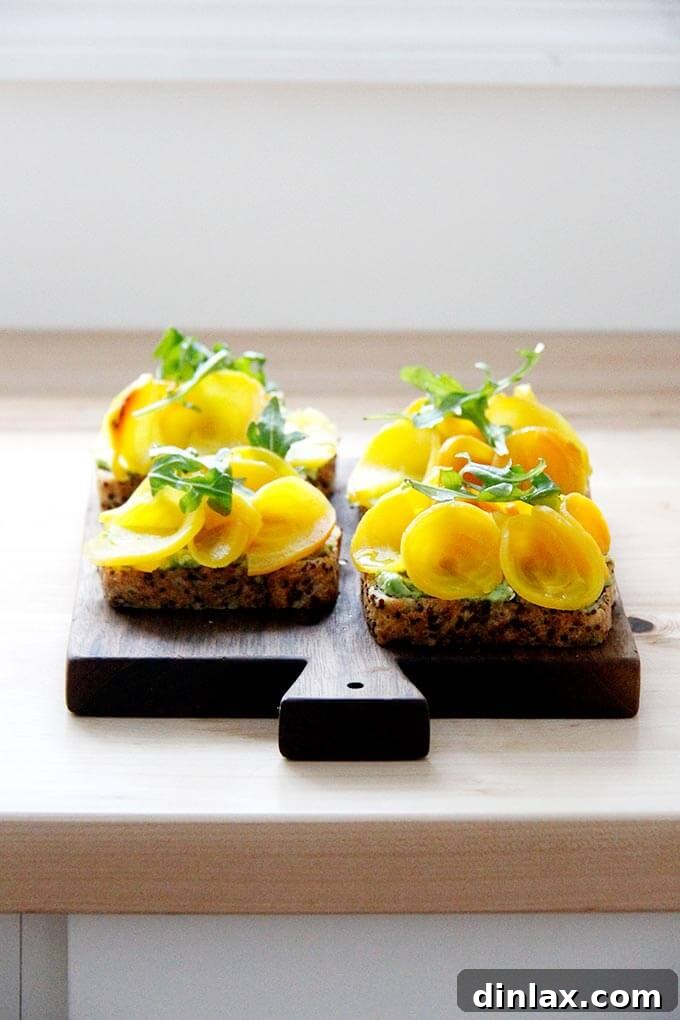 A serving board of beet tartines positioned on a kitchen counter, ready to be served.