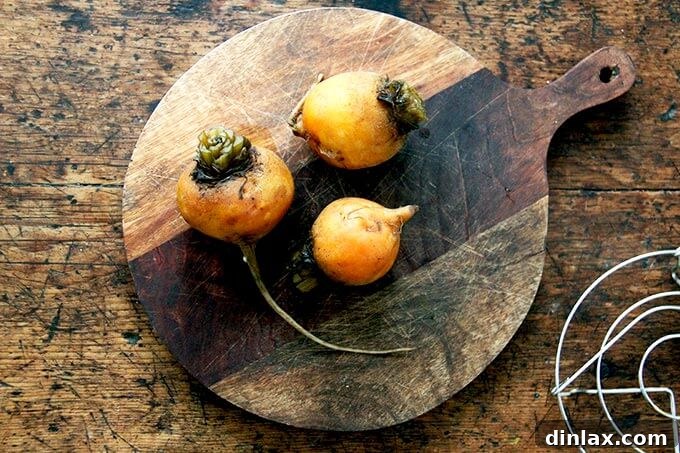 Cooked beets resting on a cutting board, having been removed from the Instant Pot.