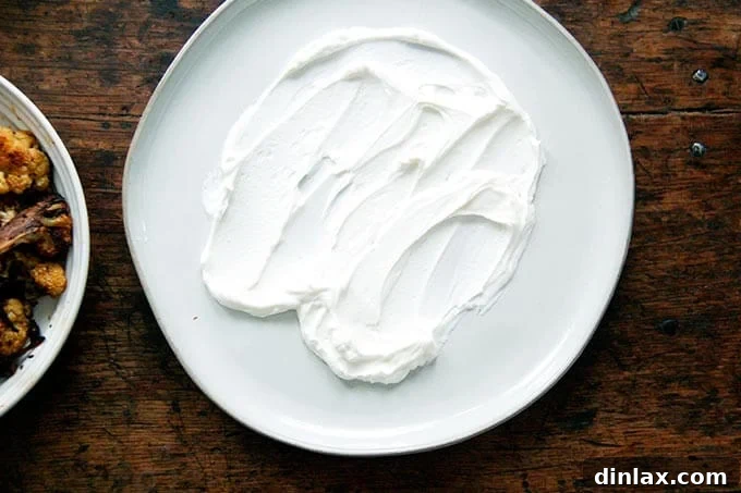 Lemony yogurt sauce spread on a platter