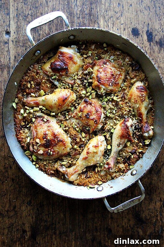 A close-up shot of Moroccan Spiced Chicken and Rice, garnished with dates and pistachios, highlighting its rich textures and colors.