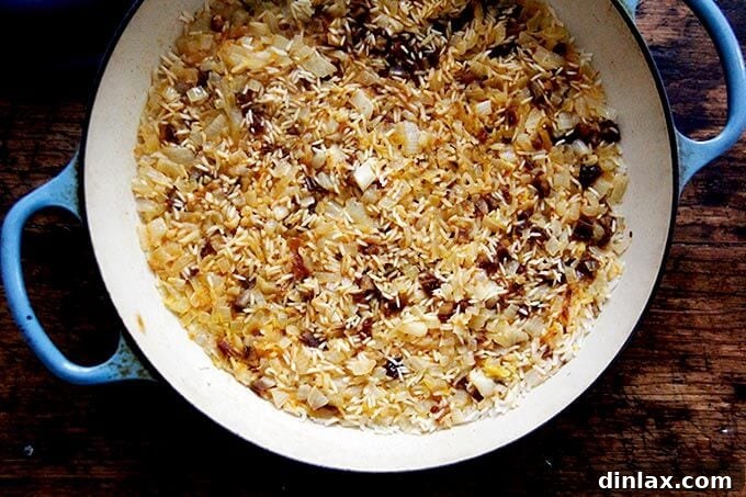 Instant Pot Harissa Rice with Sweet Dates and Zesty Orange 15 A large skillet filled with freshly cooked Moroccan Harissa Rice, fluffy and fragrant, on a stovetop, ready for serving.