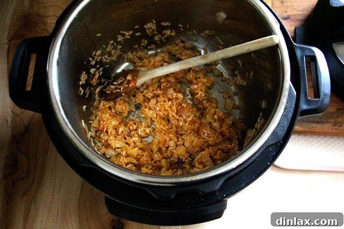 Instant Pot Harissa Rice with Sweet Dates and Zesty Orange 18 Rinsed basmati rice added to the Instant Pot with the harissa, onion, and garlic mixture, ready for a light toast.