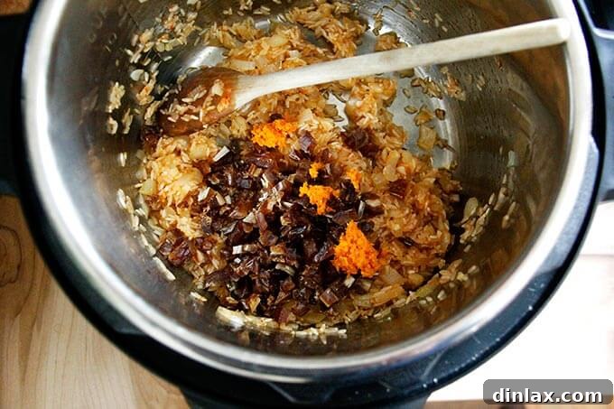 Instant Pot Harissa Rice with Sweet Dates and Zesty Orange 19 Inside an Instant Pot, the rice mixture now includes diced dates and orange zest, ready for the liquid.