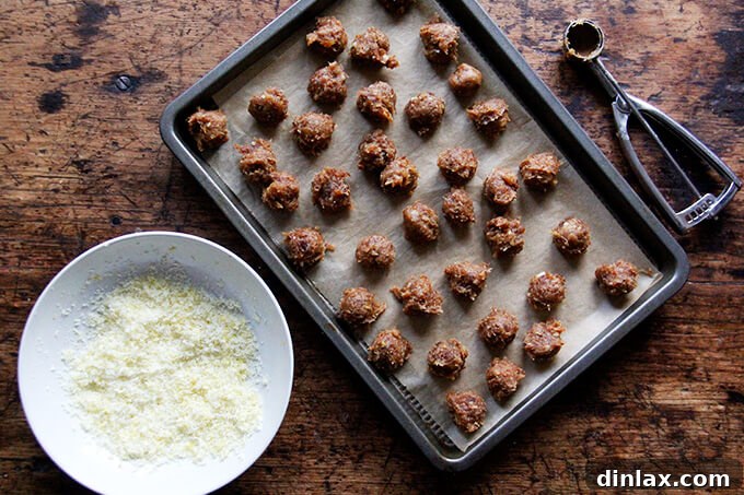 Zesty Lemon Coconut Date Bites 11 Lemon coconut date balls on a sheet pan.