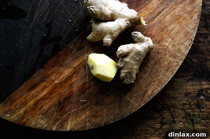 Zesty Lemon Coconut Date Bites 7 A board of fresh ginger, peeled.