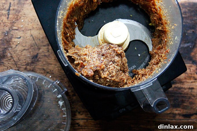 Zesty Lemon Coconut Date Bites 10 A food processor with a purée of lemon-coconut date ball batter.