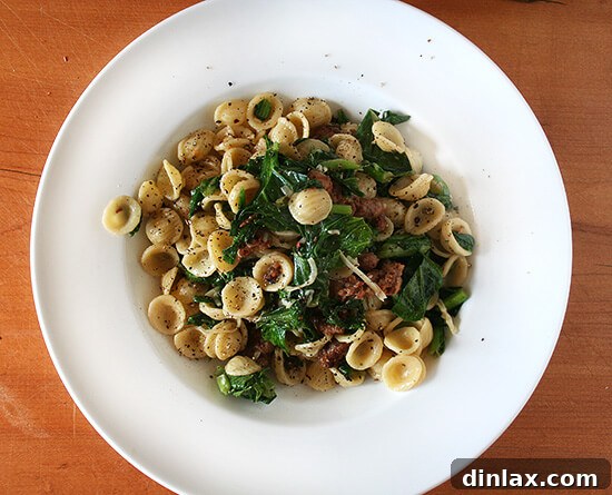 Close-up of orecchiette pasta with wilted greens, showcasing the texture and vibrant color of the dish.