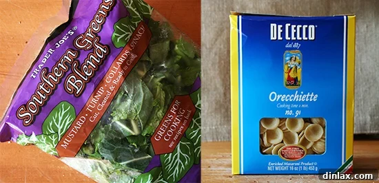 Freshly cooked orecchiette pasta tossed with vibrant wilted greens before the final additions.