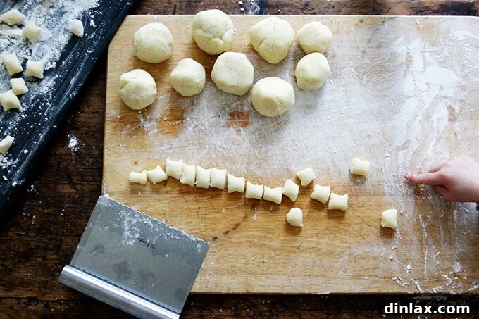 A serving of gnocchi on a plate, highlighting the rich sauce and toppings.