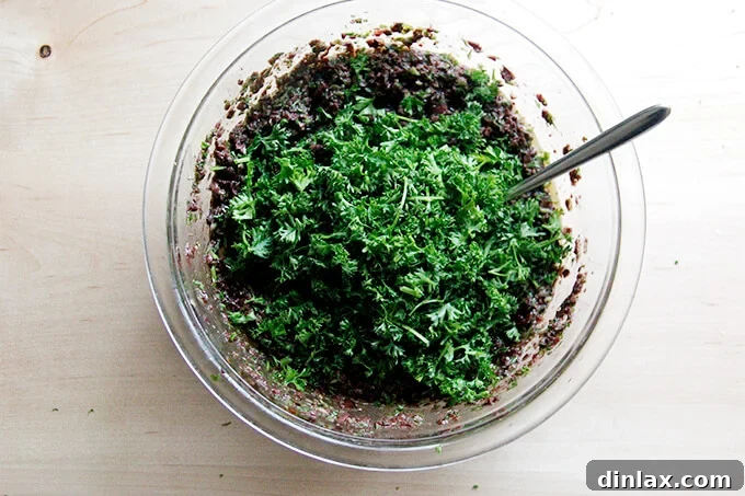 Zesty Olive Tapenade with Capers and Fresh Parsley 7 A bowl of black olive tapenade, beautifully topped with a heap of freshly chopped parsley.