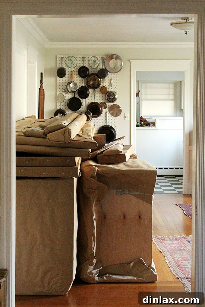 Dining room filled with kitchen cabinets awaiting installation during renovation