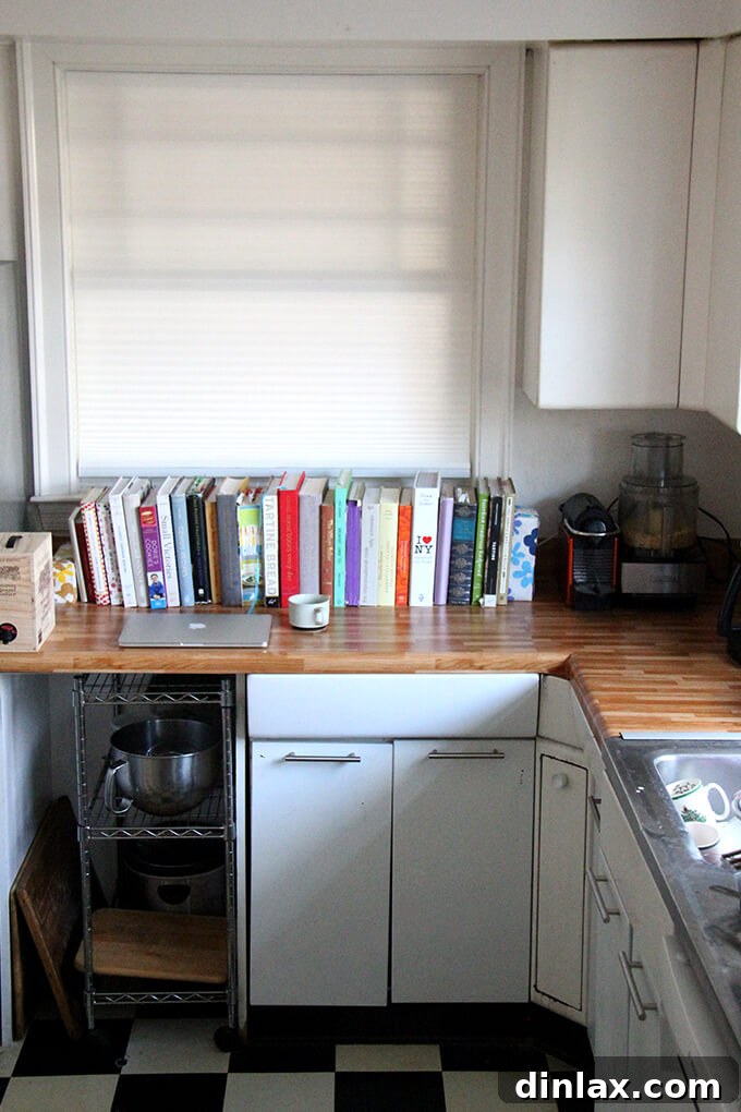 The kitchen countertops after being covered with butcher block contact paper, showing a noticeable improvement. Kitchen countertop covered with butcher block contact paper